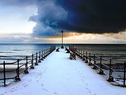 Click to view image Snow on the Jetty with Dark Skies