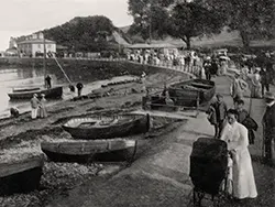 Click to view image Walkers near the Pier Entrance and wooden boats