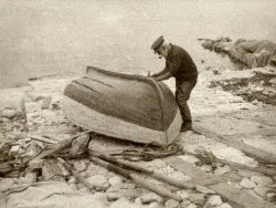 Click to view image Fisherman repairing his boat in 1928
