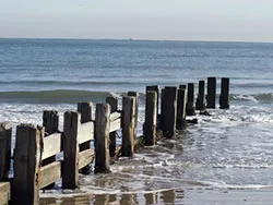 Click to view image Broken groynes on the Beach