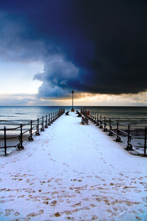 Snow on the Jetty with Dark Skies