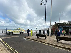 Click to view image Coastguard and Onlookers