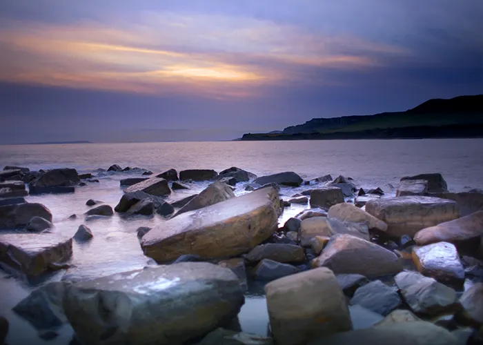 Sun setting across Kimmeridge Bay