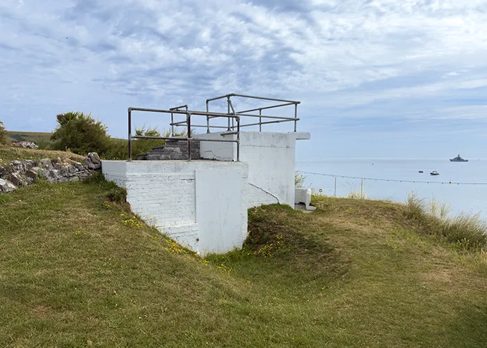 A wartime lookout still stands on the field as a reminder of 1939–45